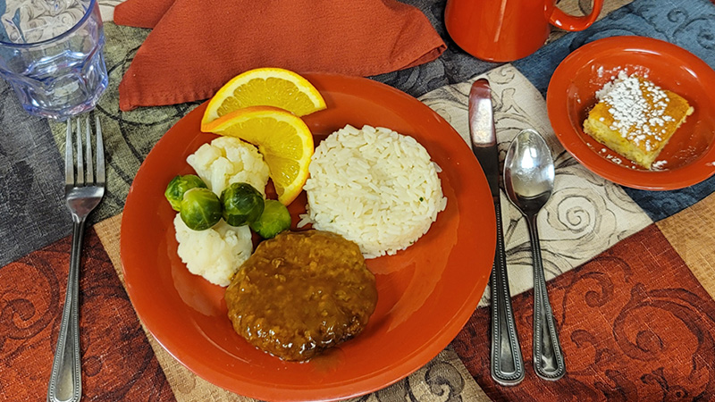 Salisbury steak dinner with rice, cauliflower and brussel sprouts