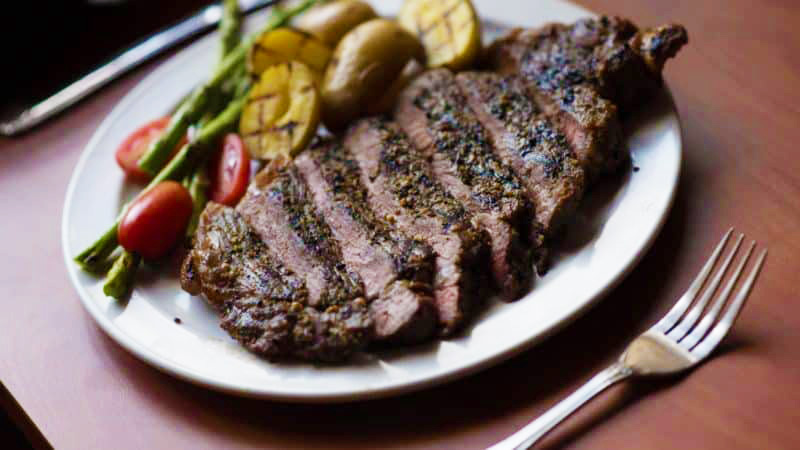 Steak dinner with mixed vegetables and grilled potatoes
