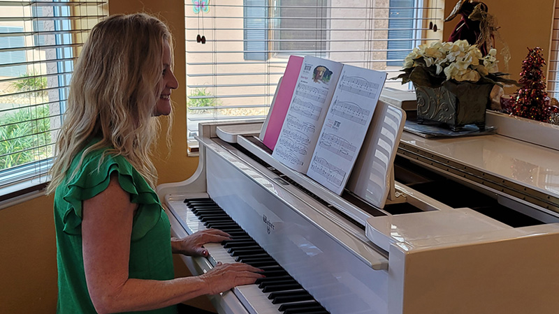 Volunteer playing the piano at Superior Residence of Lecanto